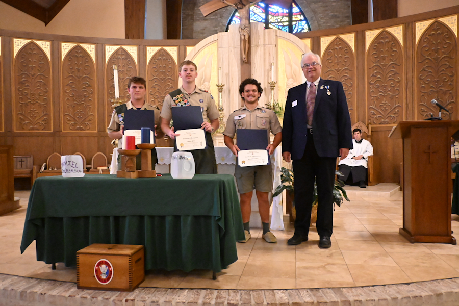 The scouts are (from left) Daniel Landreneau, Zachary Pelto and Joseph Broadwell of Troop 6 in Alexandria, La. Presented by Jim Smilie (at far right) on behalf of the Dr. Enemund Meullion Chapter Sunday, July 19, at St. Frances Cabrini Church. 