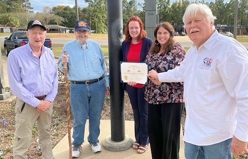 Juandie Jarrell, First Federal Bank of Louisiana in Pineville Manager, and Rebecca Gallent were presented with a Flag Certificate.