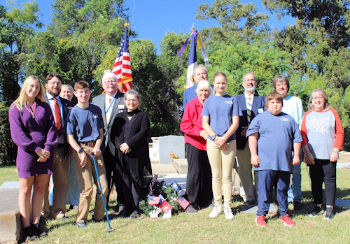 Prior to the chapter meeting, Dr. Enemund Meullion Chapter members, Fort Jesup C.A.R. members, LASSAR Ladies Auxiliary members, and guests met at the grave of Dr. Enemund Meullion for the Annual Wreath Laying in Old Rapides Cemetery.  From left: Allie Tarver (Louisiana State C.A.R. Pres.), Secretary Brent Morock, Tori Flynn (Ft. Jesup C.A.R. Senior Pres.), Nicholas Tarver (C.A.R.), President Gervais Compton, Cheryl Morock (Aux. VP), Michael Wynne, Mary Beth Tarver, Hannah Flynn (Ft. Jesup C.A.R. Pres.), Natchitoches Chapter President Tony Vets, Hayden Tarver (C.A.R.), Taylor Thompson (Dr. E.M.), and Liz Lindsay (Aux.).